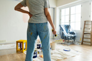 People,Renovating,The,House woman interior Painting Test Squares On Wall As she Decorates Room In New Home