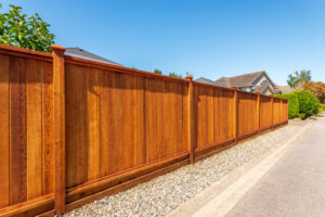 Fence Painting. New painted Fence Built From Wood. Outdoor Landscape.