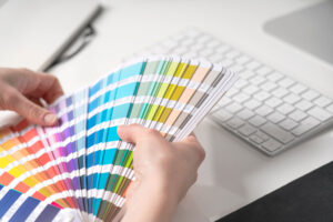 Interior Painting. Graphic Designer Chooses Colors From Palette Guide For Painting.