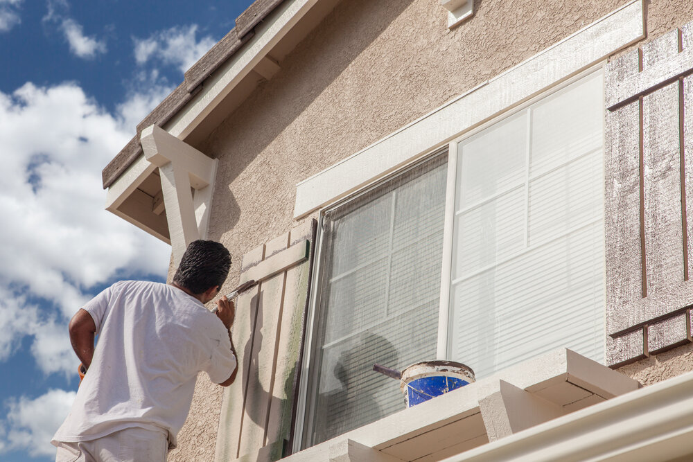 house painters. Professional House Painter Painting The Trim And Shutters Of A home.