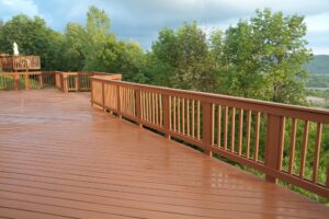 Why Islanders Choice Is #1 for Deck Painting in Victoria. A freshly painted and stained wood deck with railing on a summer afternoon after a rain shower.