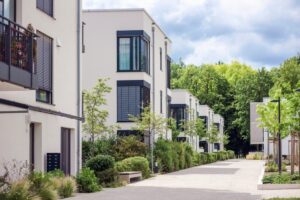 Why Choose Islanders' Choice for Strata Painting in Victoria? Residential Apartment Building Landscaping. New Houses Modern Home Complex with Green Landscape Design.